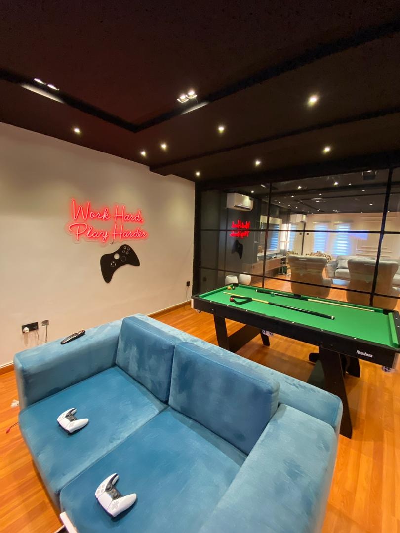 Games room with neon signage